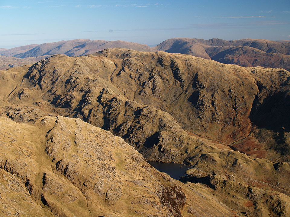 Looking over Levers Water to Black Sails and Wetherlam to Helvellyn and Fairfield from the summit of Coniston Old Man