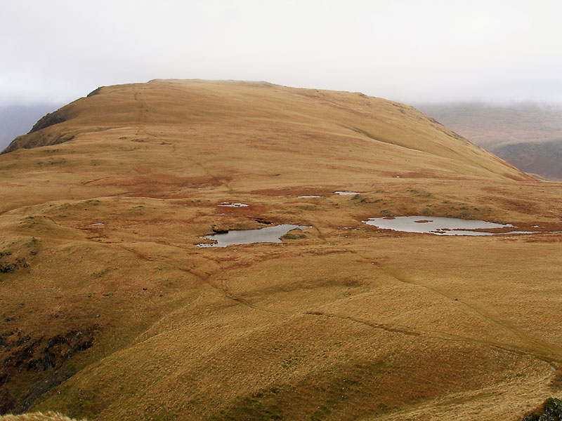 Illgill Head in mist over the tarns from Whin Rigg