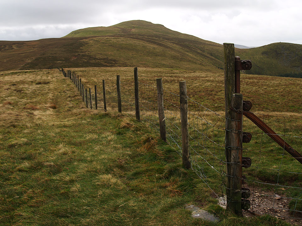 The summit of Burnbank Fell is marked by the straining post on the right looking back to Blake Fell