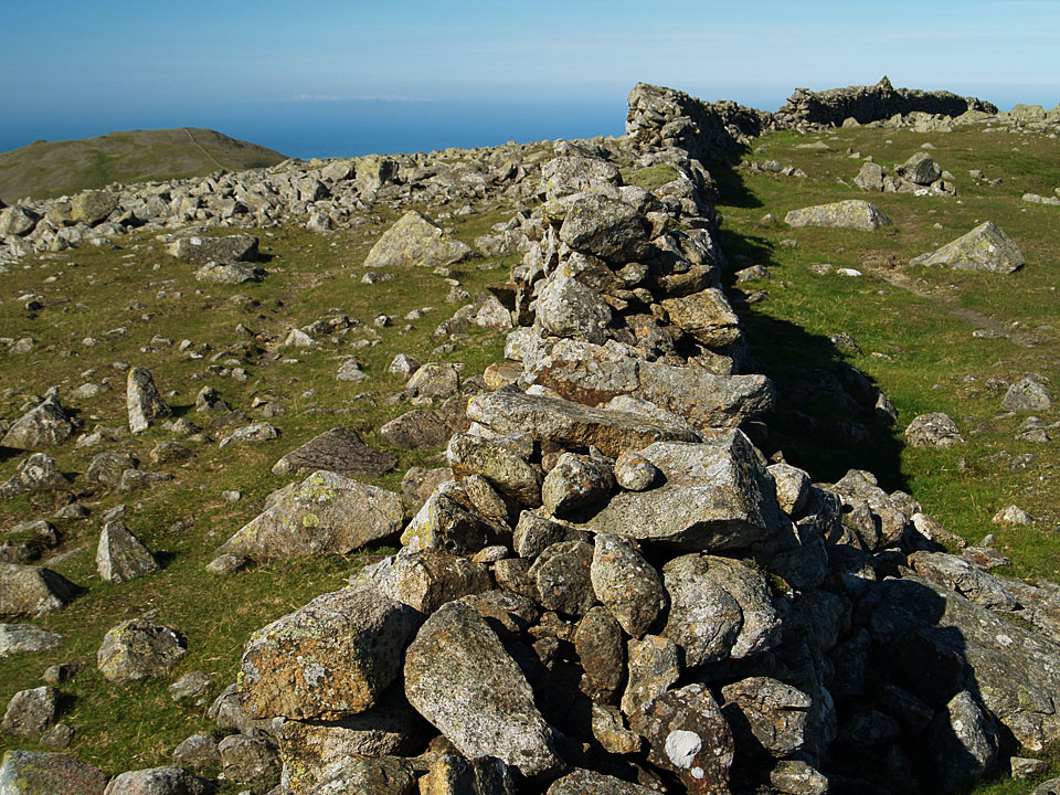The summit of Scoat Fell, the summit cairn is atop the wall on the upper right.