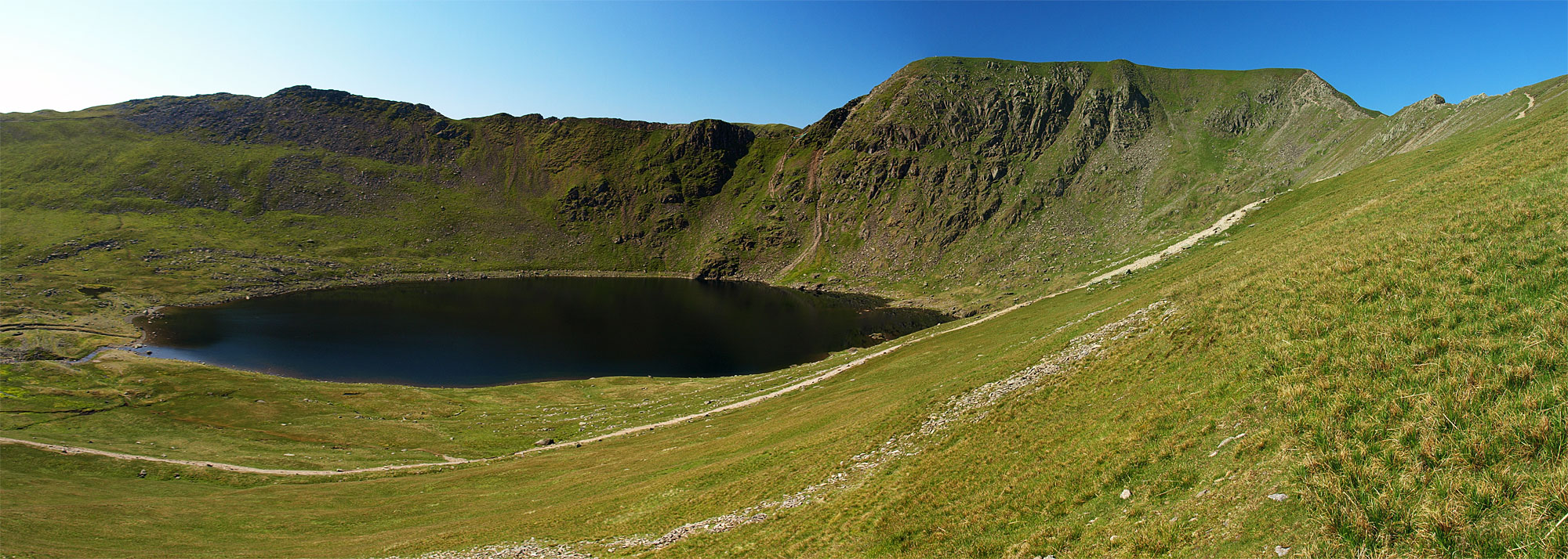 Striding Edge and Helvellyn across Red Tarn from the steep descent from Catstycam